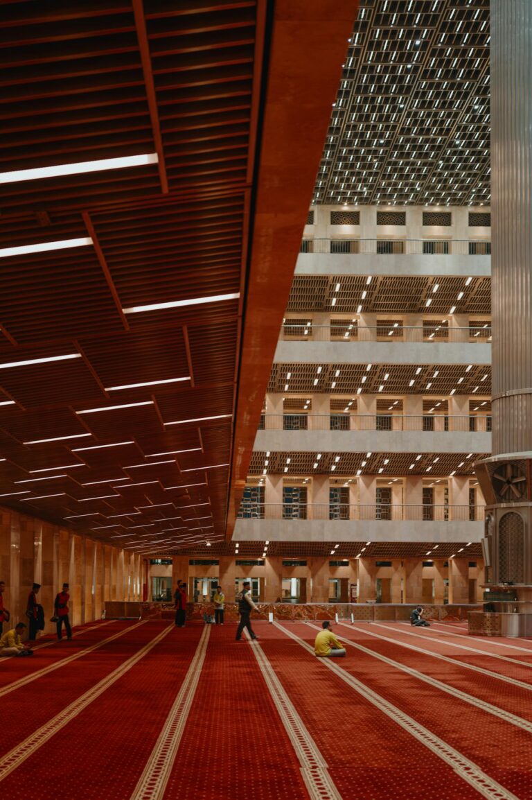 Beautiful interior of Istiqlal Mosque with worshippers in Jakarta, Indonesia.